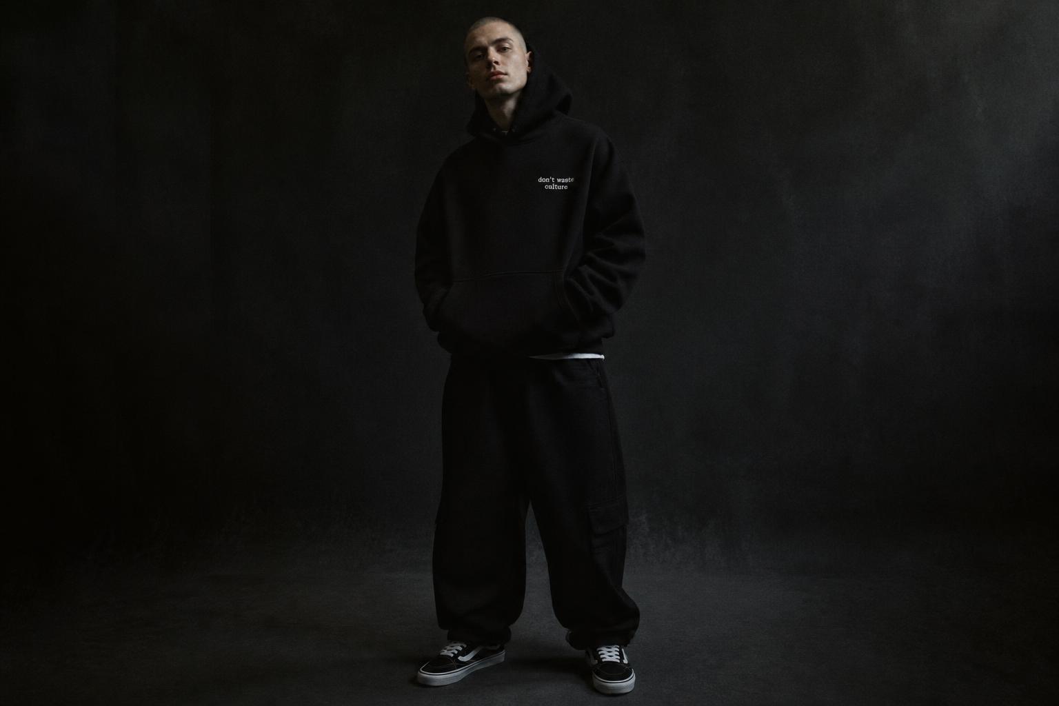 Model wearing the LYXE heavyweight black hoodie and cargo pants